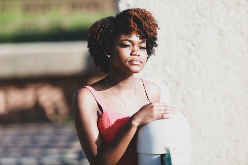 Beautiful Woman Standing by Railing and Looking Away