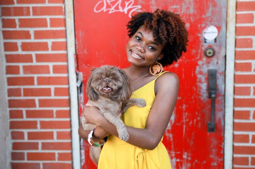 Happy Woman in Yellow Dress Posing with Dog