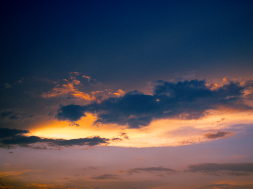 Free Breathtaking sunset with dramatic clouds and a vibrant sky, creating a scenic view. Stock Photo