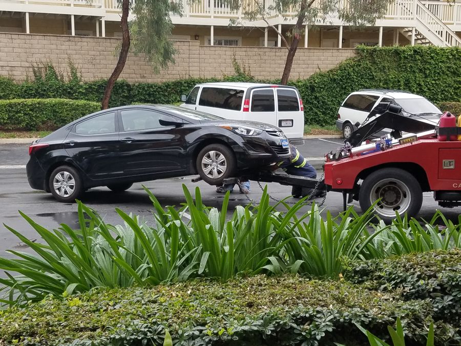 Car with a flat tire being loaded onto a Northgate tow truck