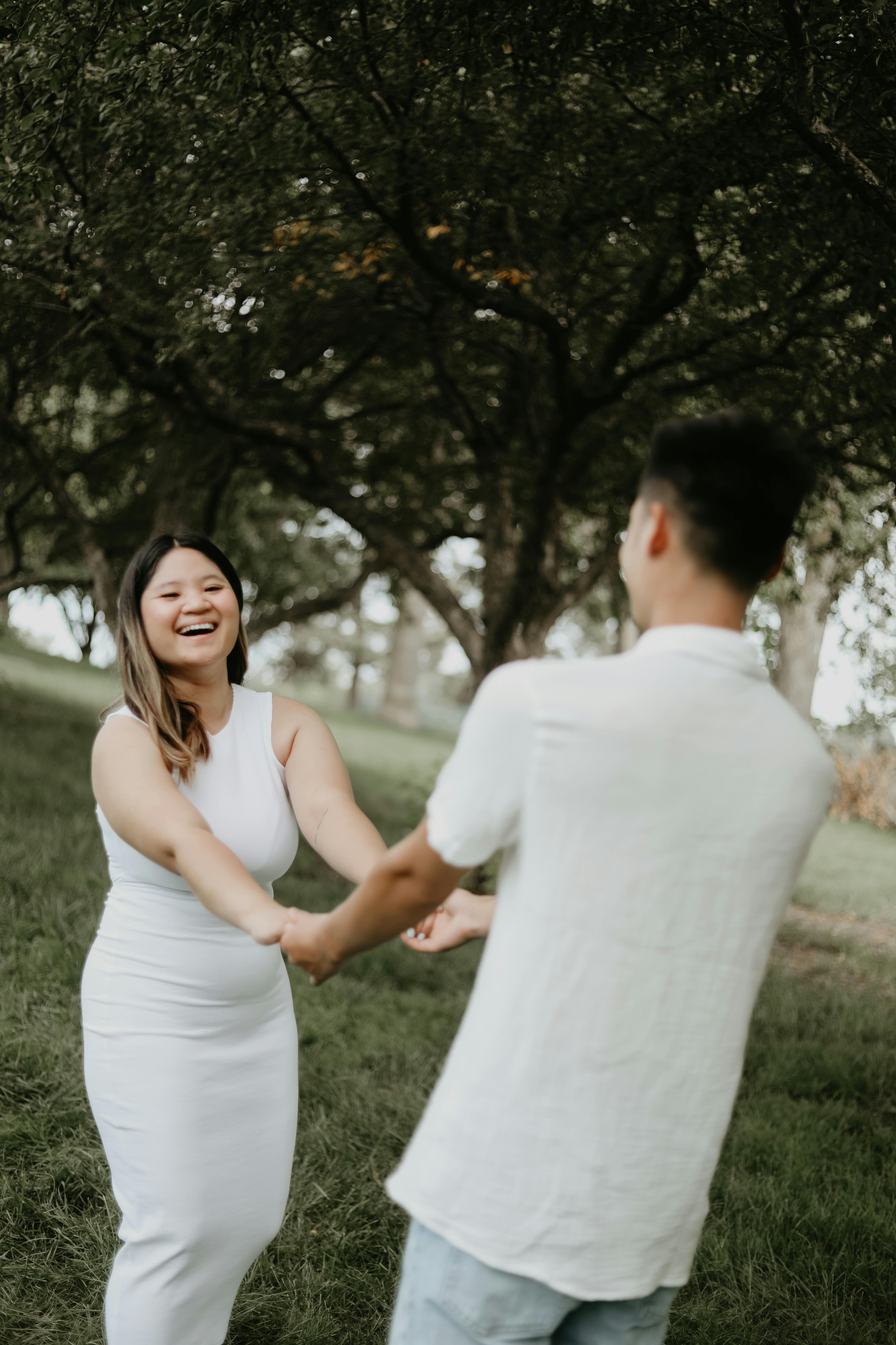 Back View of Couple in Dress and Shirt Holding Hands in Forest · Free ...