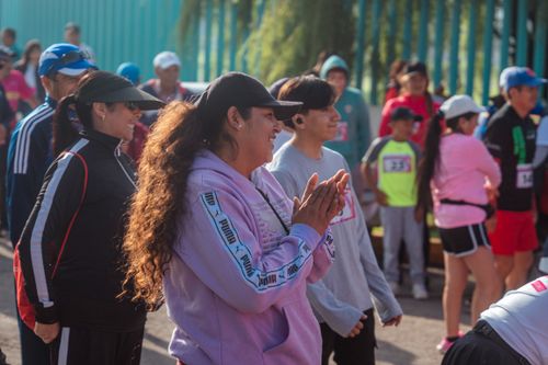 Free Group of people engaged in a lively community fun run event, enjoying the outdoors. Stock Photo