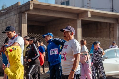 Free Participants engage in a vibrant marathon event, showcasing diverse attire and lively atmosphere. Stock Photo