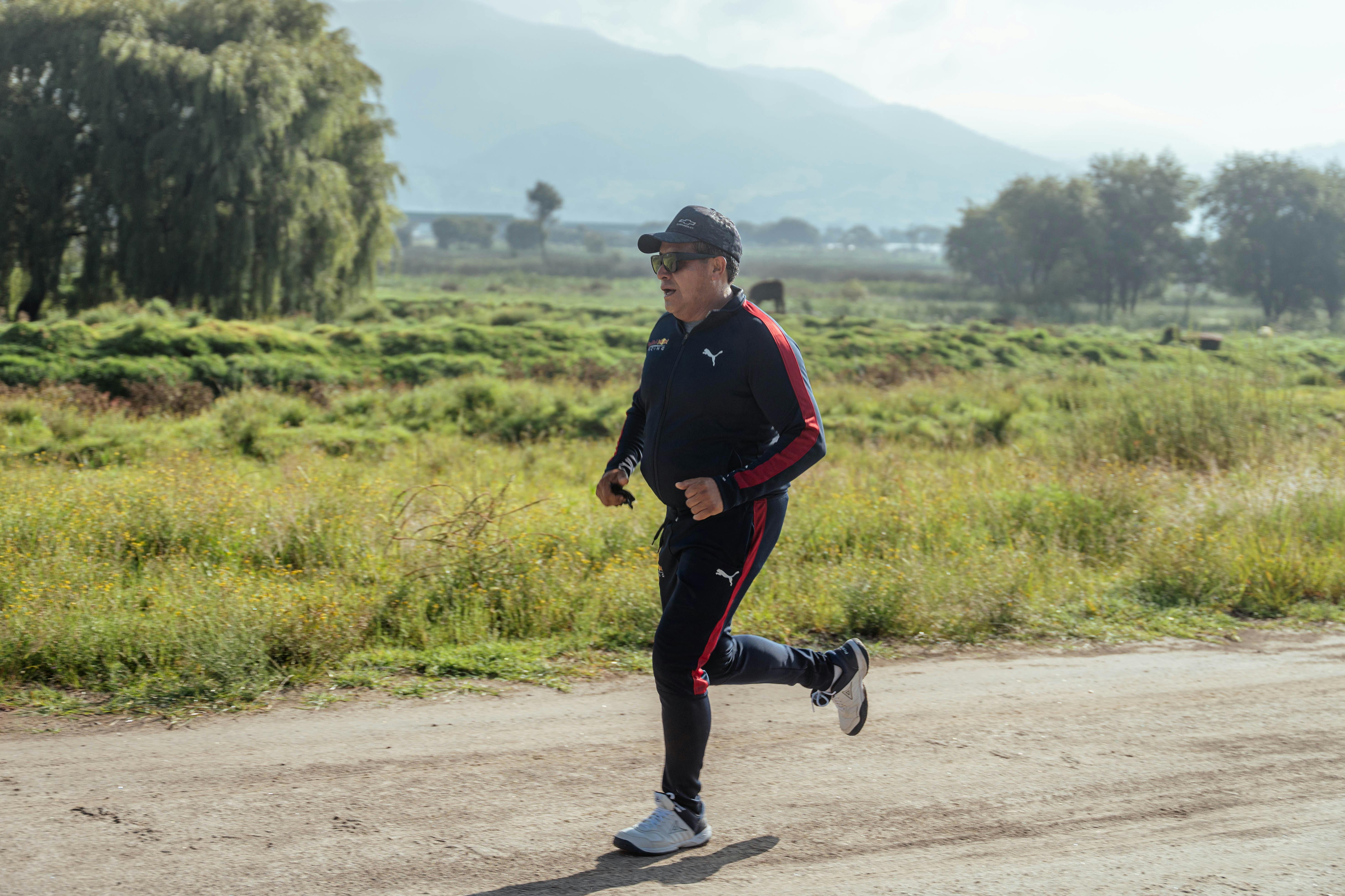 Man Running on Dirt Road · Free Stock Photo
