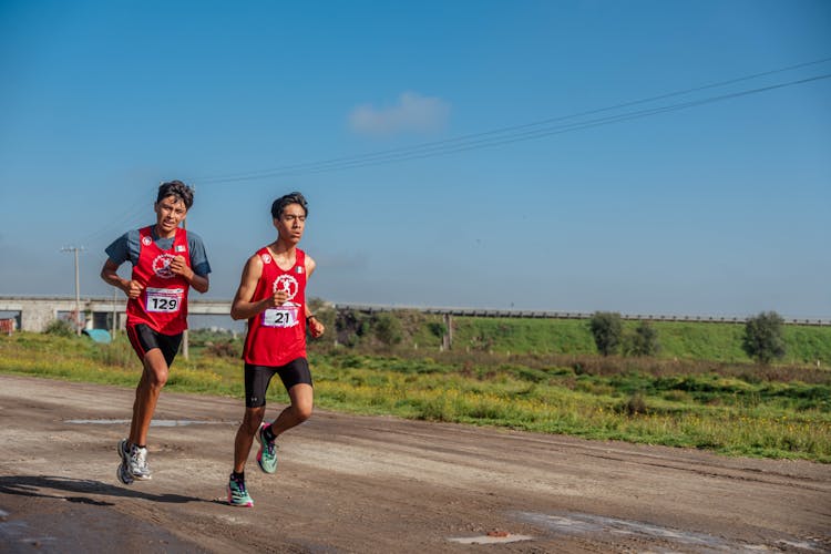 Men Running In Race On Dirt Road 