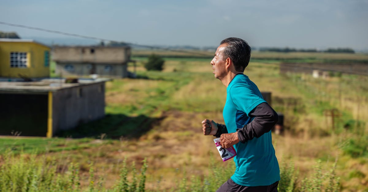 A man jogs in rural area wearing sportswear, emphasizing fitness and determination.