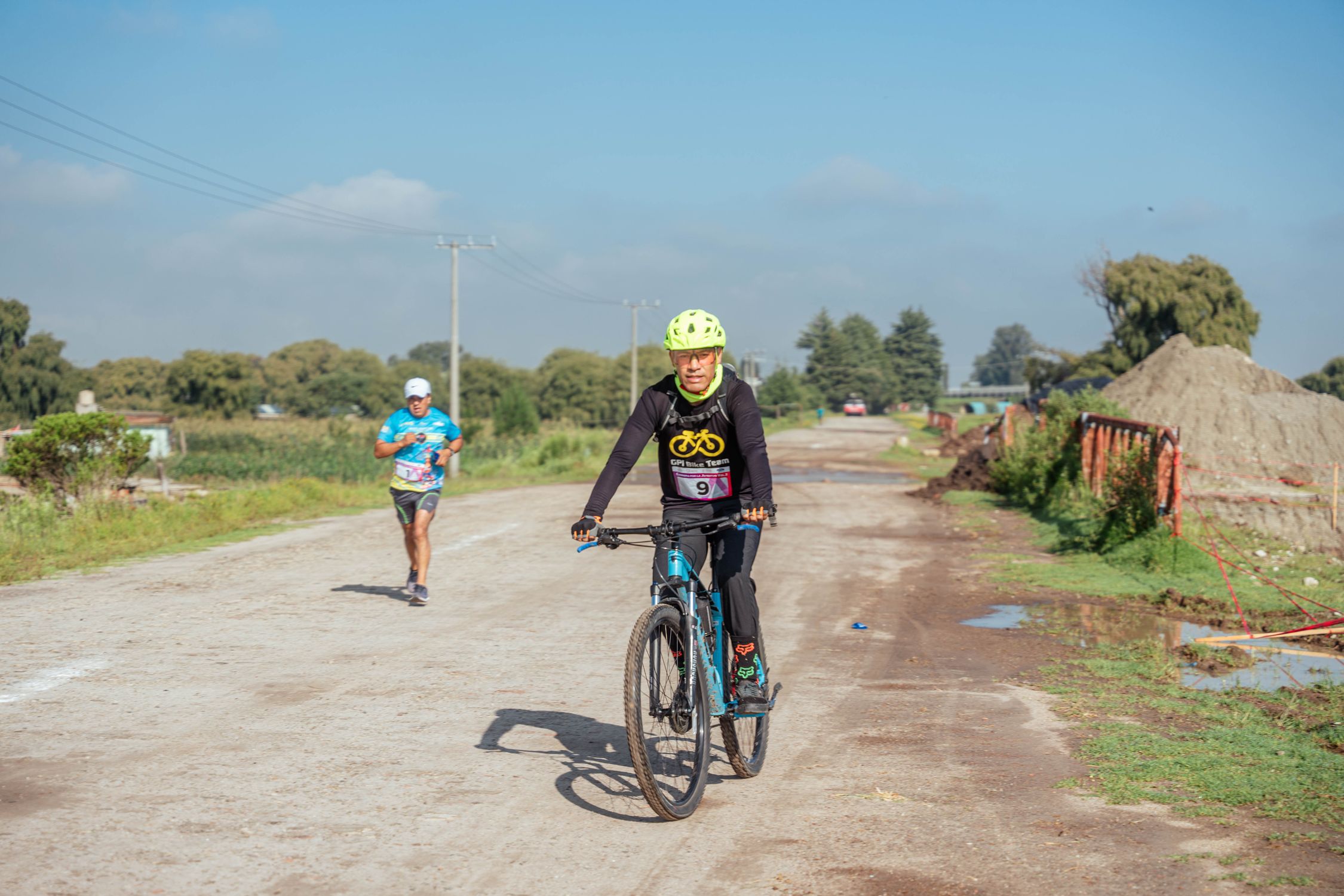 Man on Bike and Running in Race in Village · Free Stock Photo