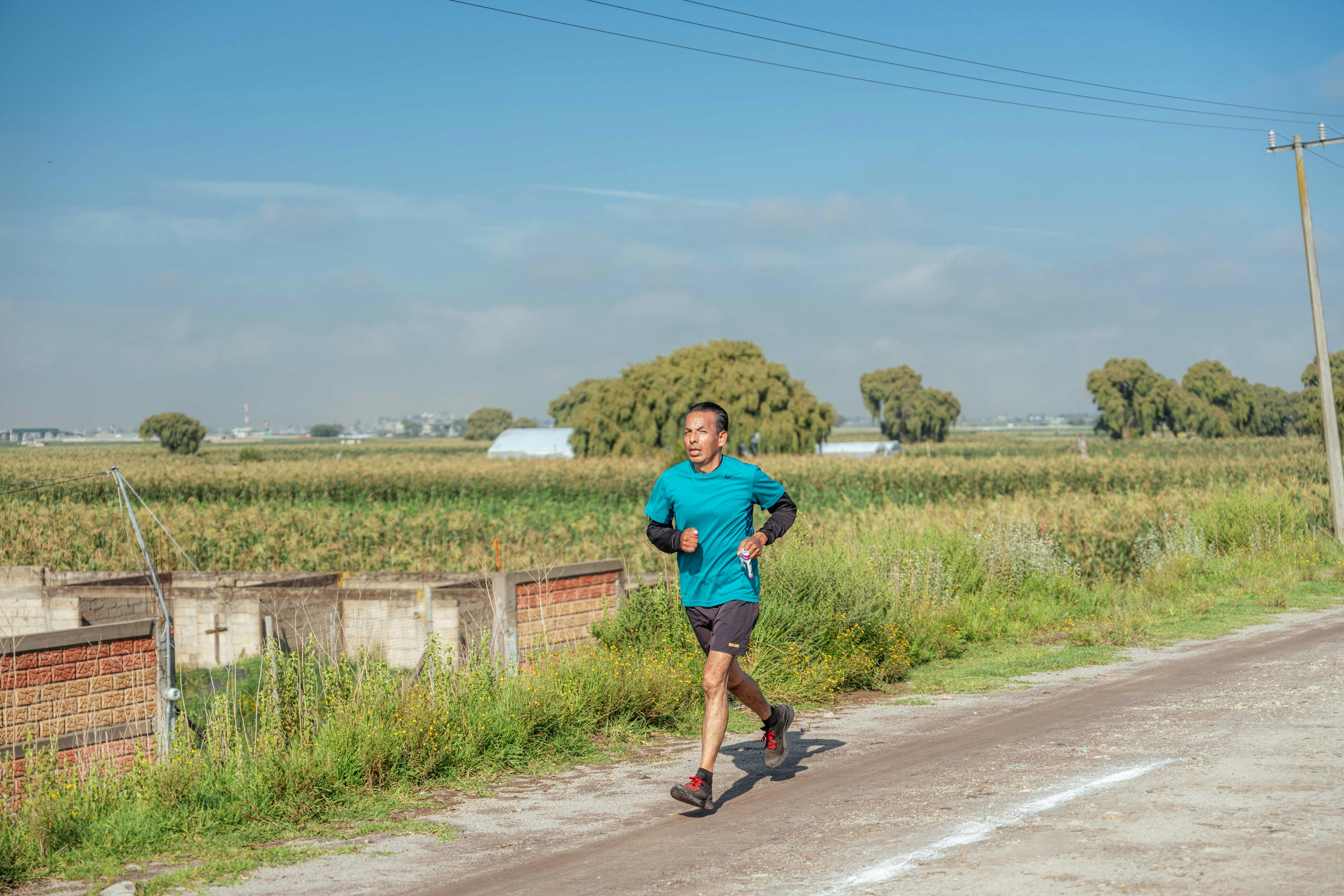 Man Running on Dirt Road · Free Stock Photo