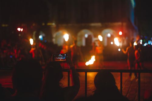 Free A vibrant night scene showcasing a street fire performance with audience capturing the moment. Stock Photo