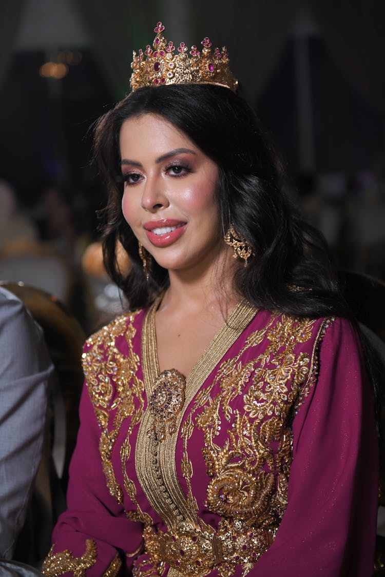 Smiling Woman In Traditional Dress And Crown