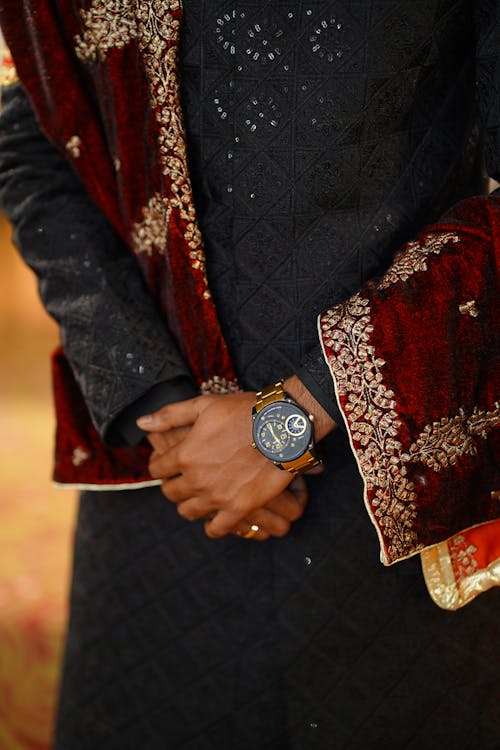 Hands of Man in Traditional Clothing