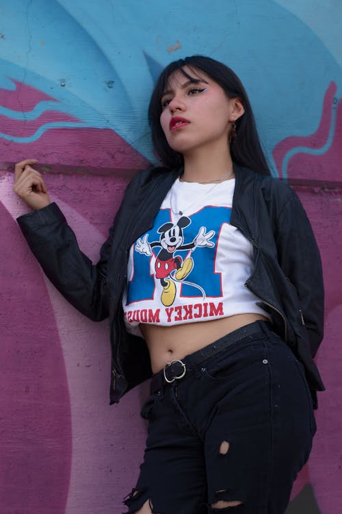 Young Woman Posing near Graffiti Wall