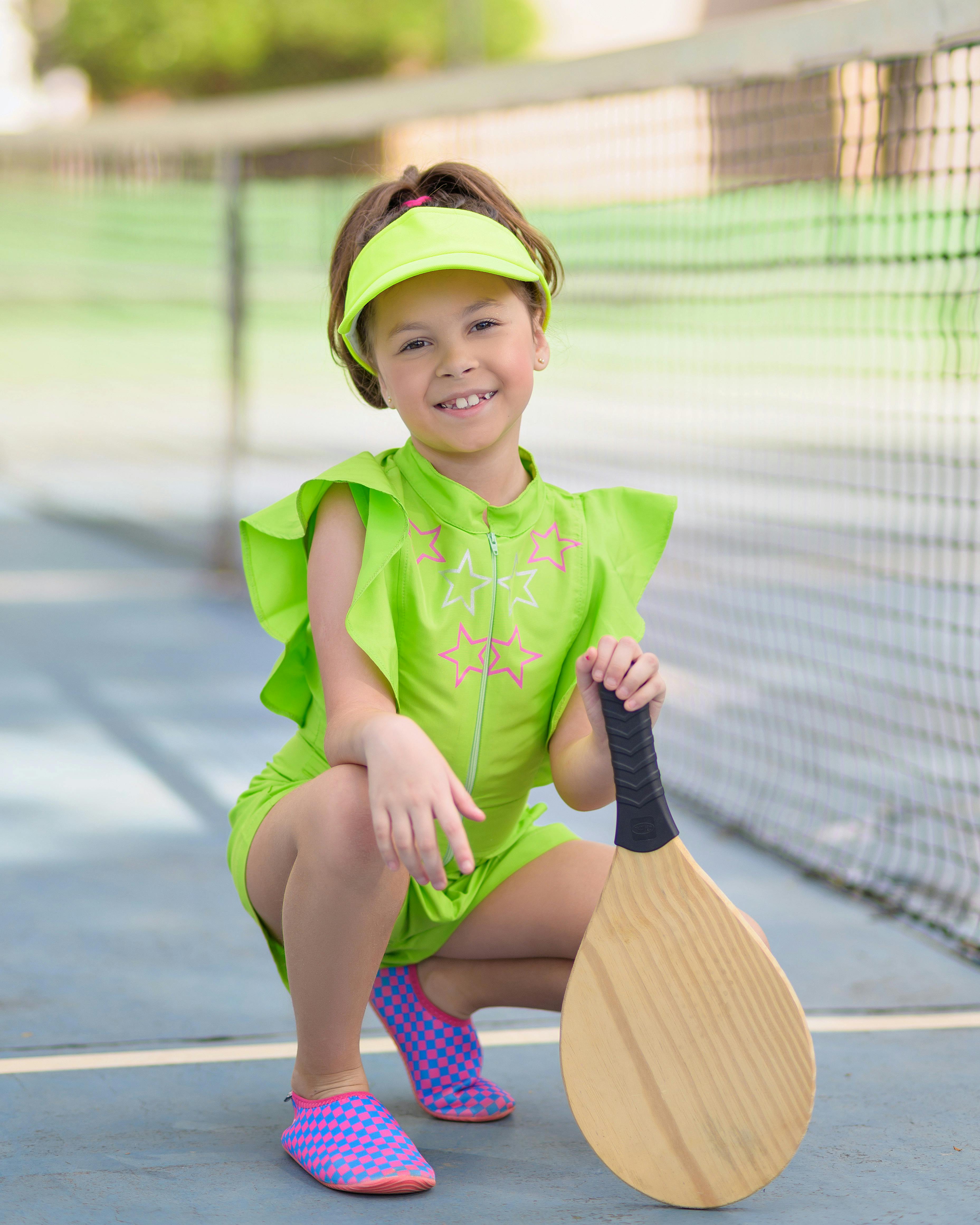 smiling girl with racket posing on court