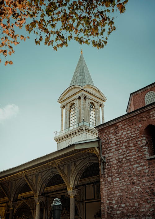 Old Brick Building with Tower against Blue Sky