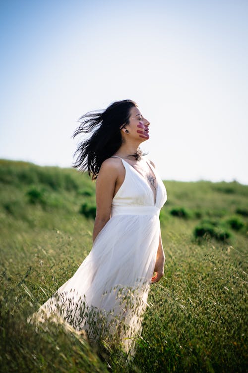 Woman Wearing White Dress on a Meadow