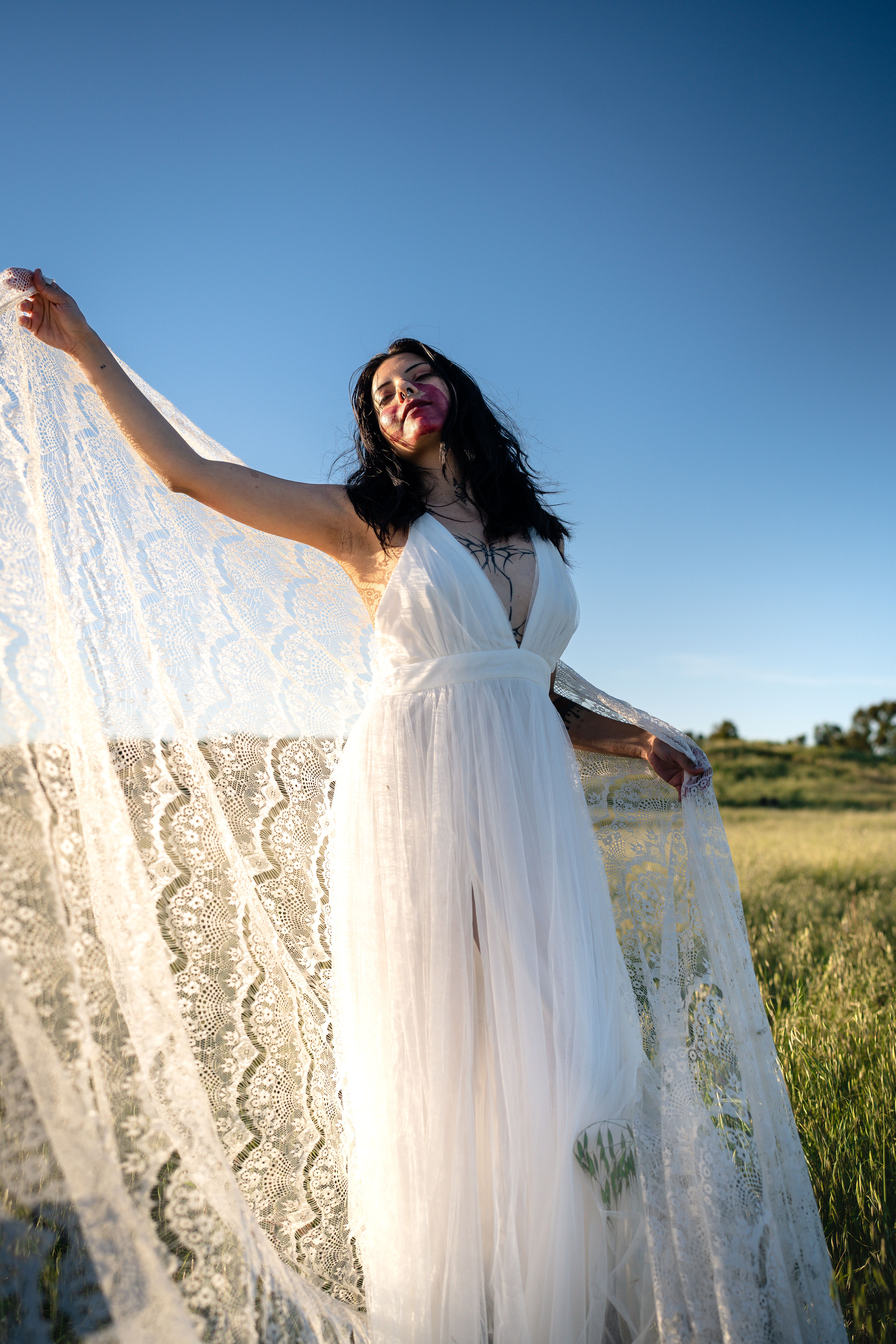 Young Woman in White Dress Posing in Field · Free Stock Photo