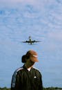 Airplane Flying over Man in Cap