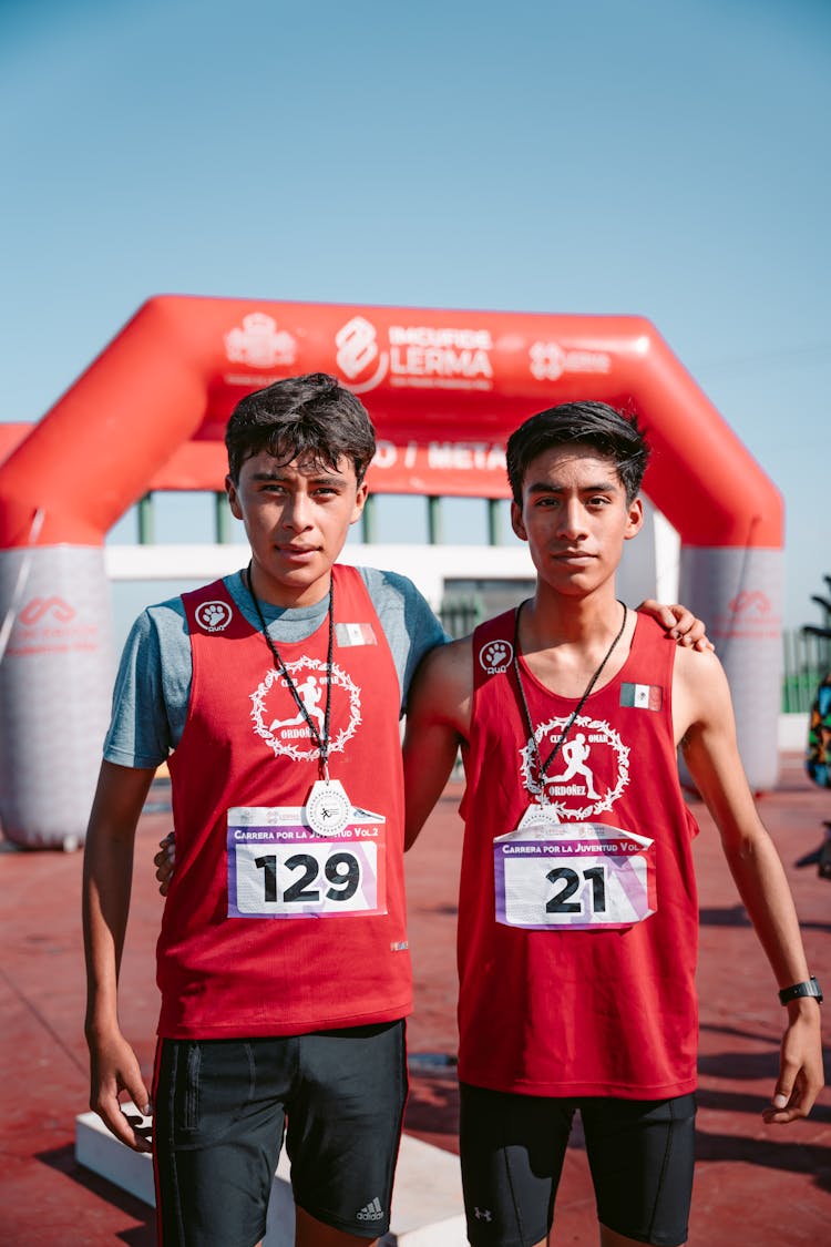 Men With Medals Standing On Finish Line