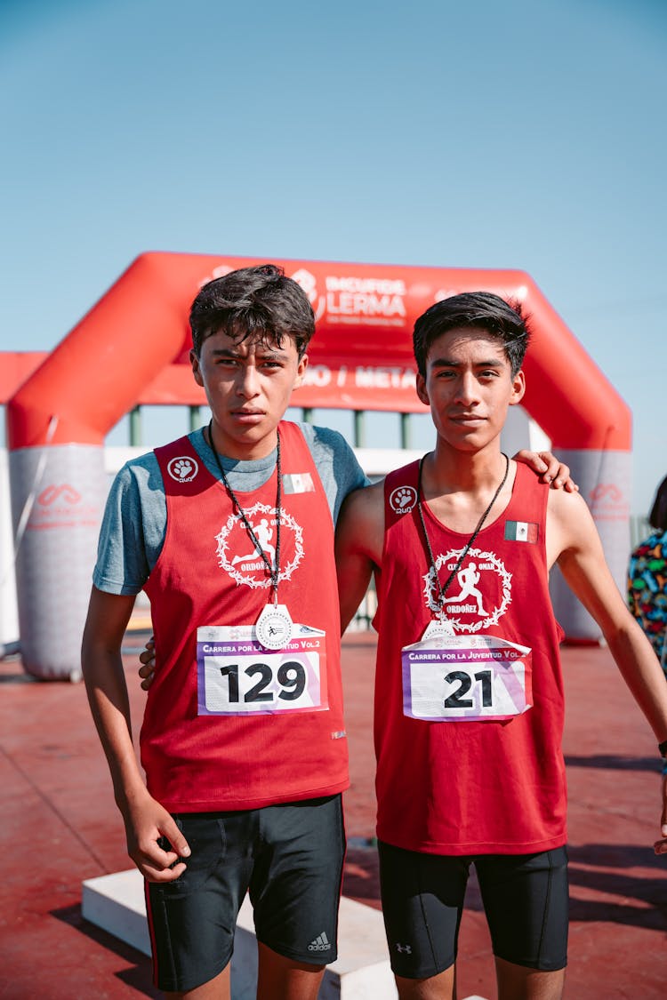 Embracing Men Standing On Finish Line