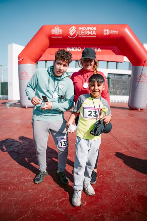 Free A family poses proudly after completing a marathon, showcasing their medals. Stock Photo