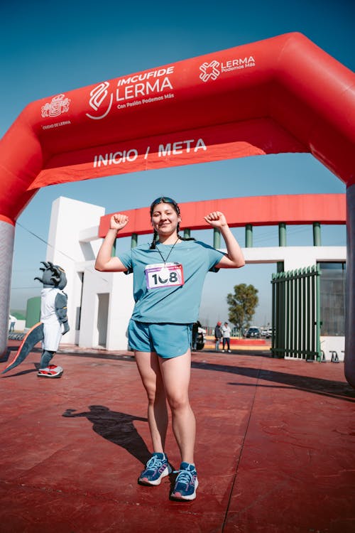 Woman Posing like a Winner on Finish Line