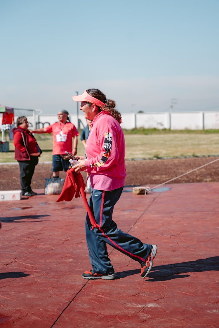 Woman Walking On Red Pavement