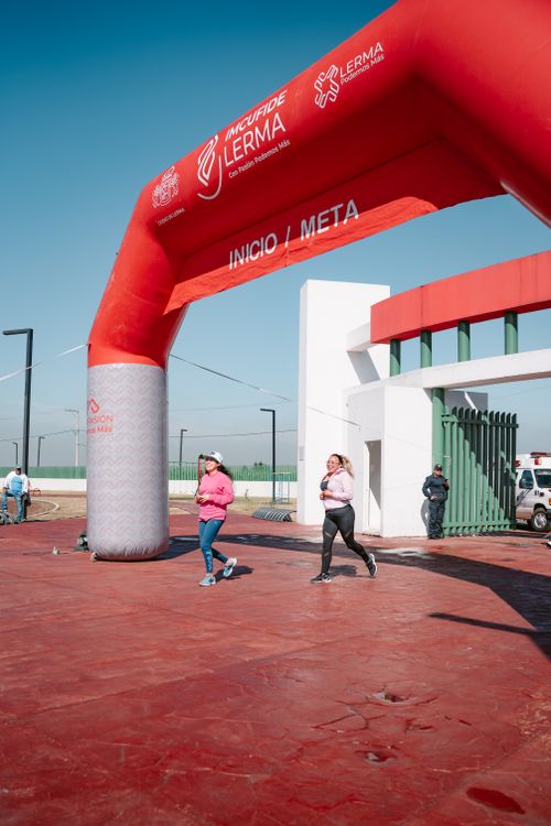 Running Finish Gate Women Running through Start and Finish Gate · Free Stock Photo
