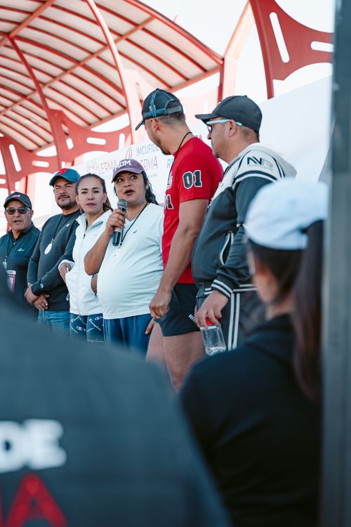 Free A diverse group of adults speaking at an outdoor event, with a focus on community interaction. Stock Photo