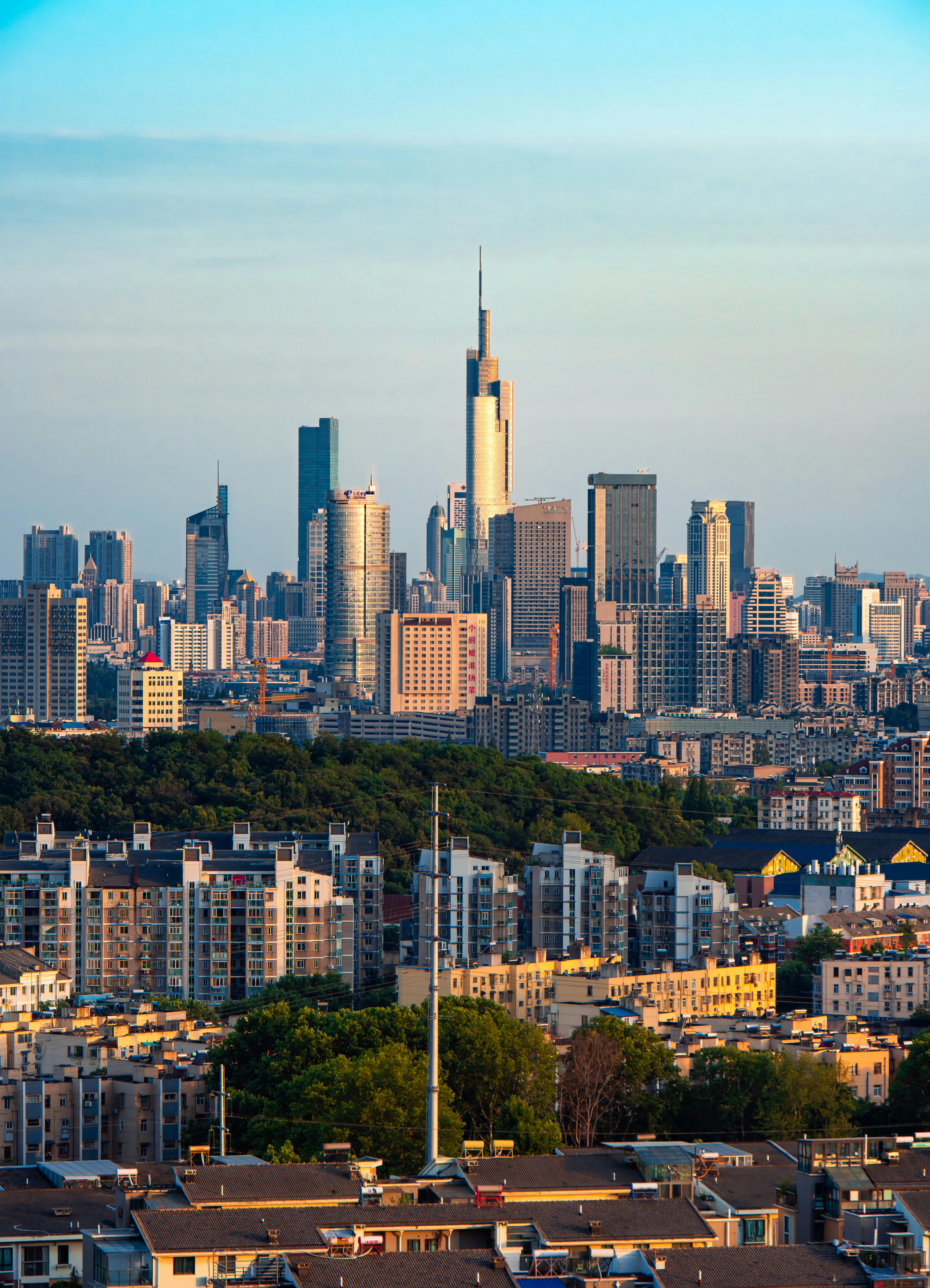 Breathtaking view of Nanjing's urban skyline with iconic skyscrapers at sunset.