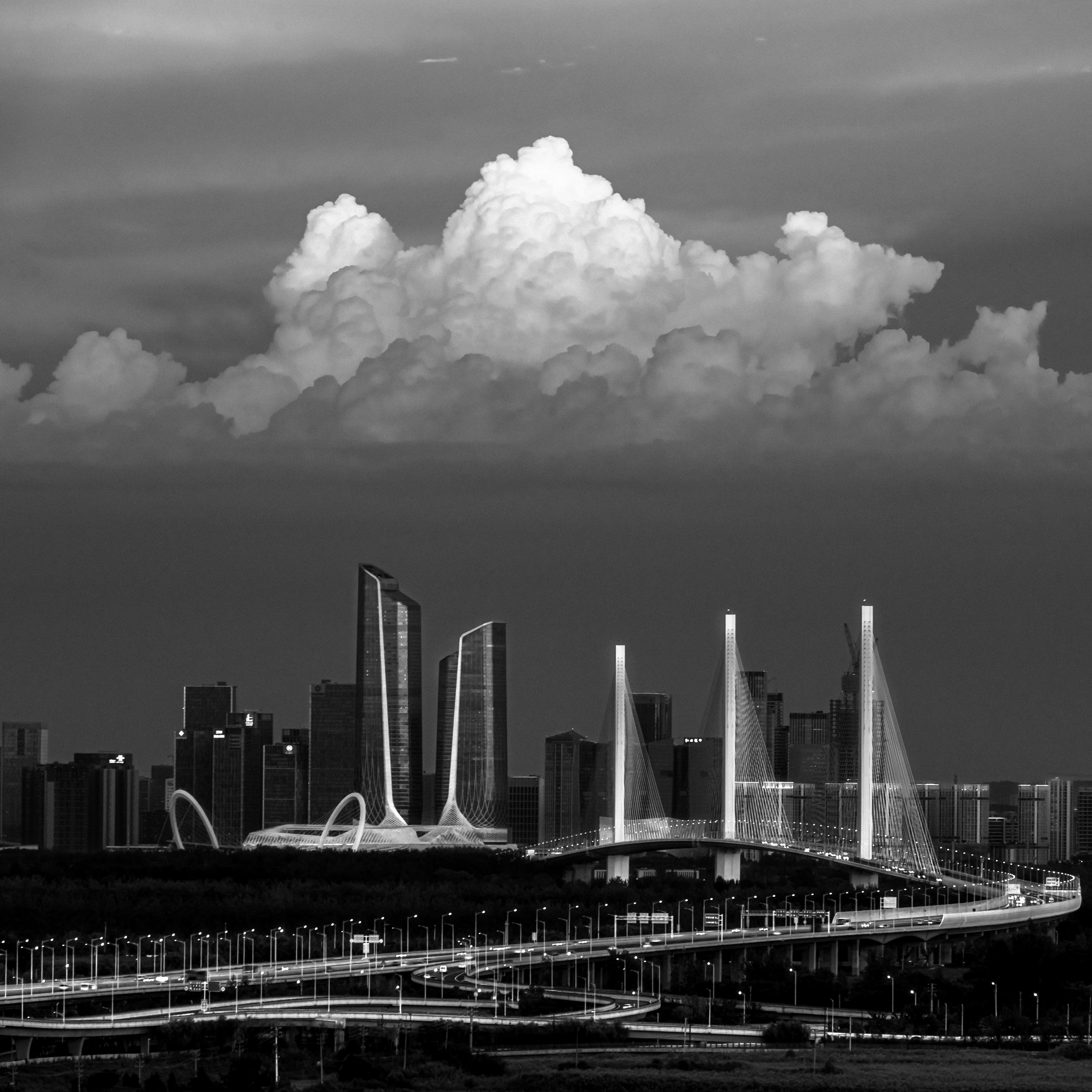 Clouds over Modern Bridges and Skyscrapers in City in Black and White ...