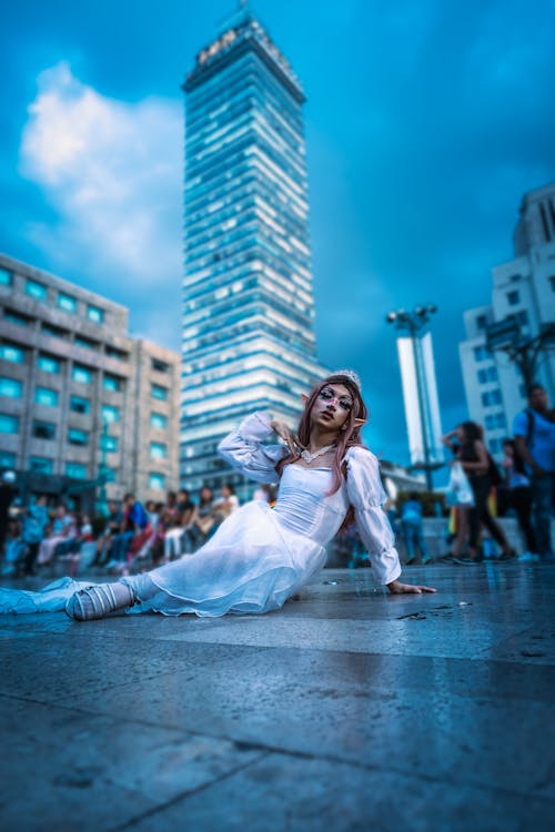 Woman in White Dress Posing with Torre Latinoamericana behind