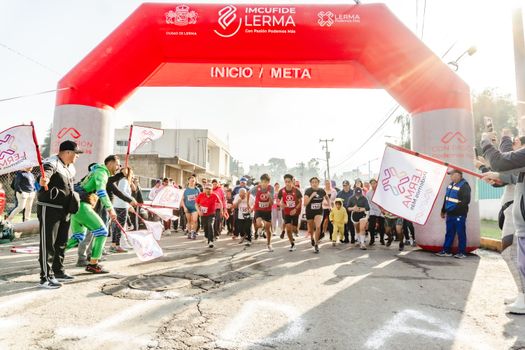 Exciting start of a local running event in Santa María Atarasquillo, México.