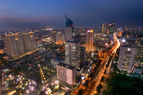 Free A stunning aerial view of Jakarta's skyline highlighting modern skyscrapers and vibrant city lights. Stock Photo