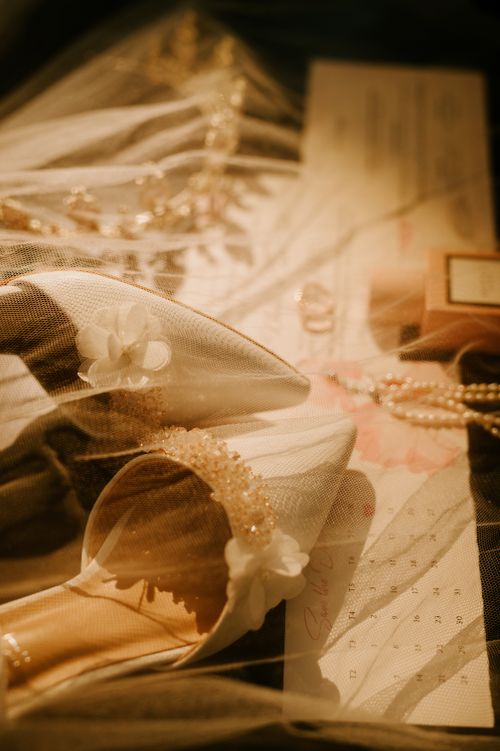 Free A delicate flat lay showcasing elegant bridal accessories, heels, and a veil. Stock Photo