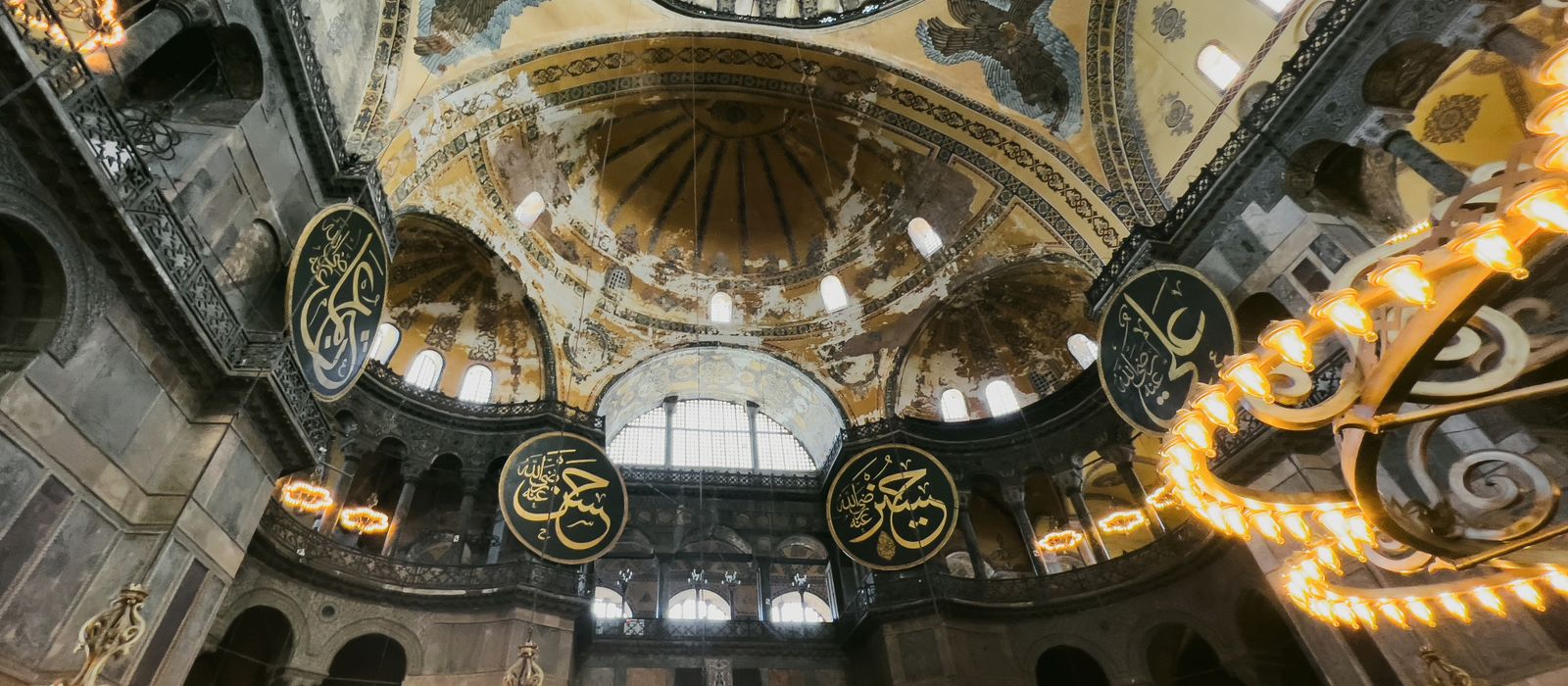 Captivating interior view of Hagia Sophia Mosque in Istanbul, showcasing intricate dome architecture and decorative elements.
