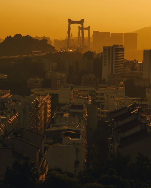 Free Explore Xia Men Shi's stunning skyline with this dramatic sunset cityscape featuring bridges and modern architecture. Stock Photo