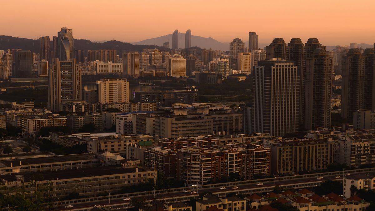 Aerial view of Xiamen's modern skyline of skyscrapers along the waterfront at dusk