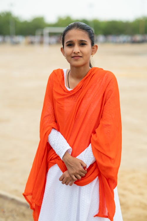 Young Woman in Red Dupatta Scarf and White Dress