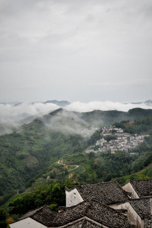 Village with a View of the Mountains Covered with Clouds