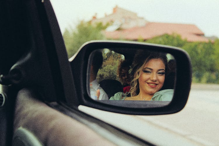 Woman Reflecting In Side Car Mirror