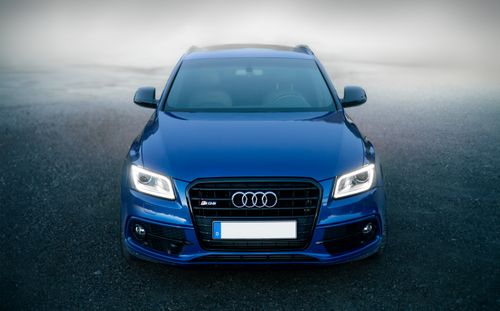 Free Stunning frontal shot of a modern blue luxury SUV outdoors. Stock Photo