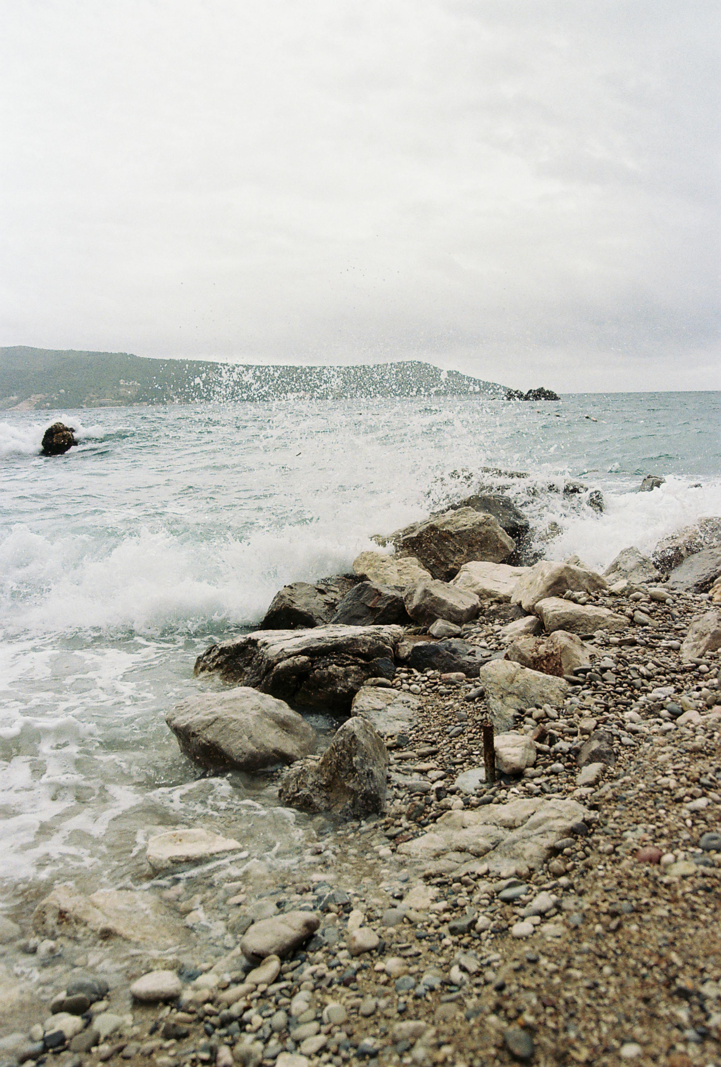 close up of wave crushing on rocks on shore