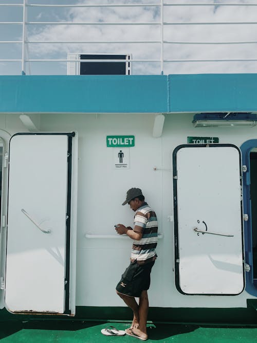 Visitor Waiting in Front at the Hatch to the Toilet on the Ship