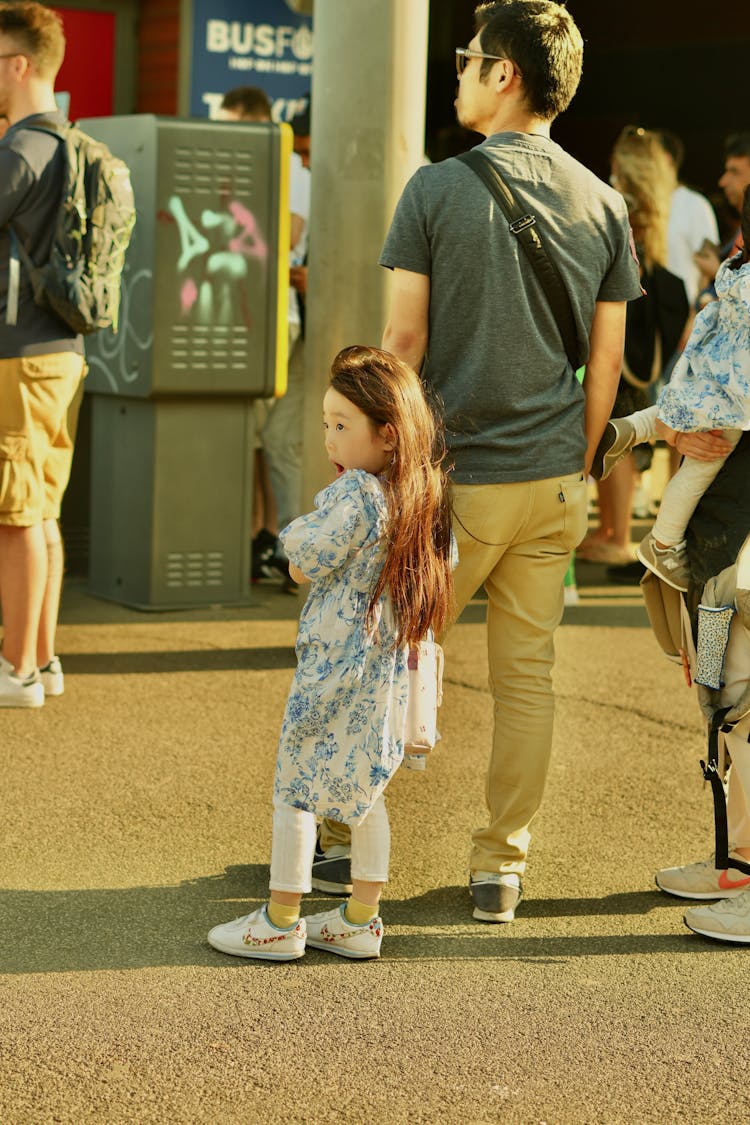 Father And Daughter Standing In Line