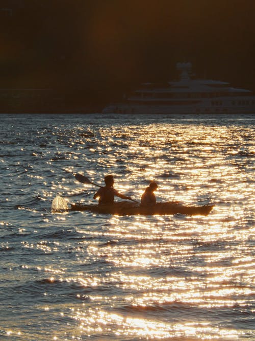 People Canoeing at Sunset