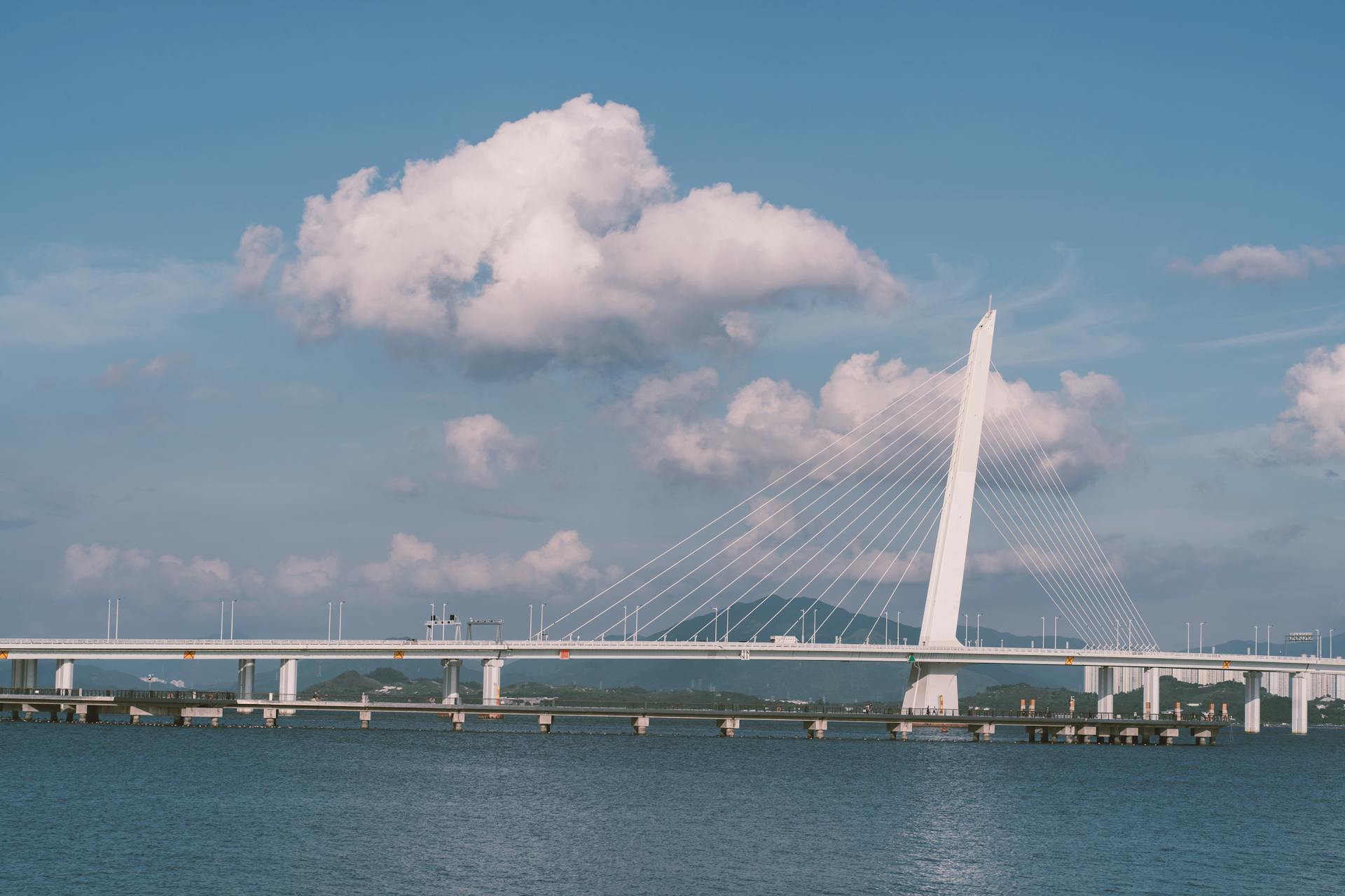 Stunning view of Shenzhen Bay Bridge under a clear blue sky, showcasing modern architectural design.