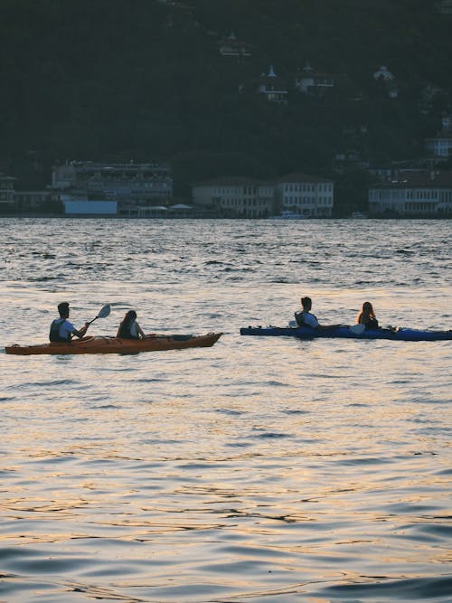 People Canoeing on Sea Coast