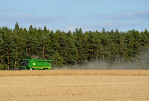 Free View of a Combine Harvester on a Crop  Stock Photo