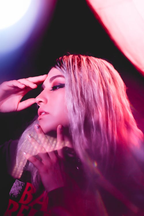 Studio Shot of a Young Woman in Pink Lighting 