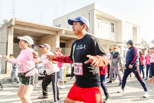 People on a Street in City Participating in a Marathon 